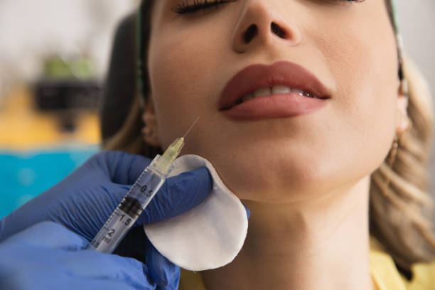 Young woman getting an injection of dermal filler with hyaluronic acid