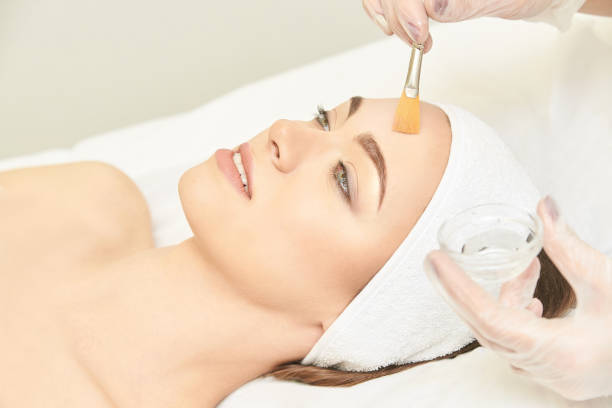 Facial brush peel retinol treatment. Beauty woman peeling procedure. Cosmetology young girl therapy.Hyaluronic acid.