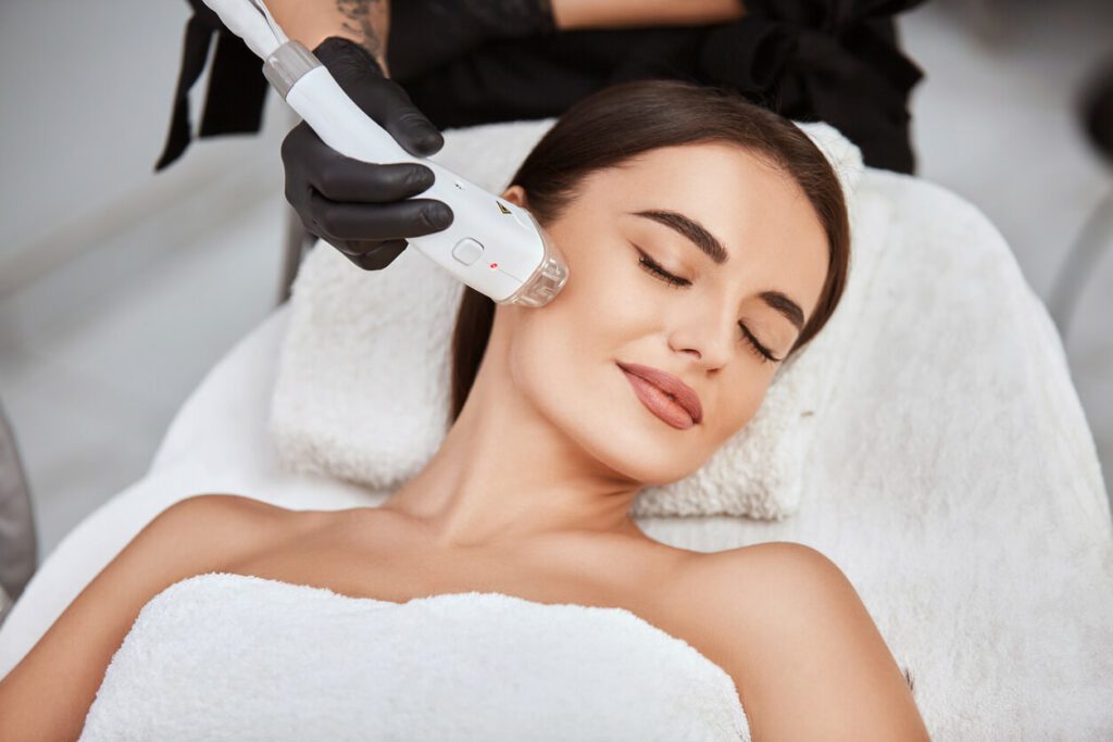 Image of a woman receiving a facial massage treatment in a med spa.
