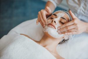 Close-up portrait of an organic facial mask application at spa salon.